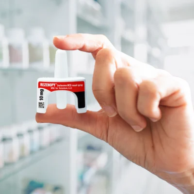 rezenopy-10mg-naloxone-nasal-spray-device-isolated Hand holding a 10 mg Rezenopy (naloxone HCl) nasal spray device